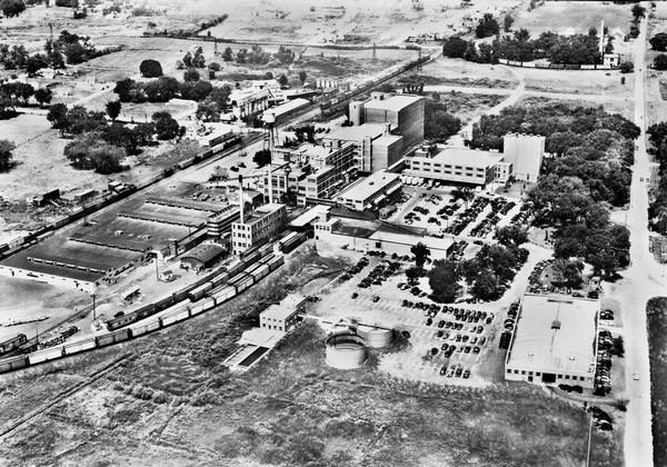 Aerial view of Oscar Mayer & Company, 910 Mayer Avenue at Packers Avenue. Shows stock yards, railroad cars and automobile parking lot. Also shows C.E. & P.A. Roth coal silos.