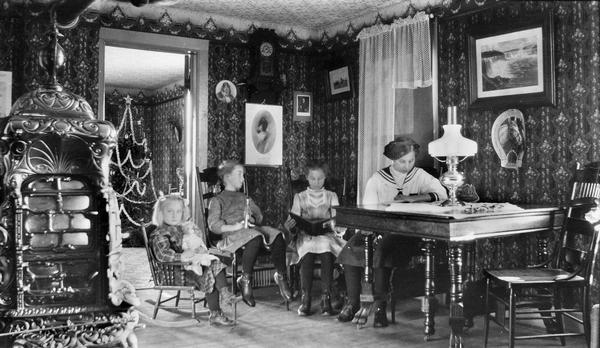 Four Jacobson daughters in living room with an ornate stove and a Christmas tree in the back room.