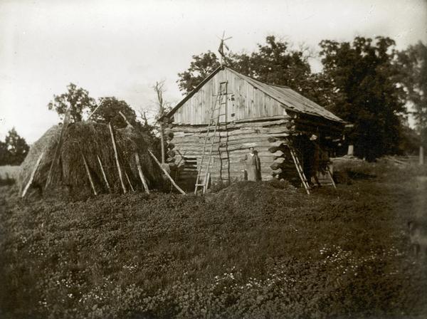 Log cabin barn and haystack.