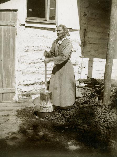 Woman churning butter.