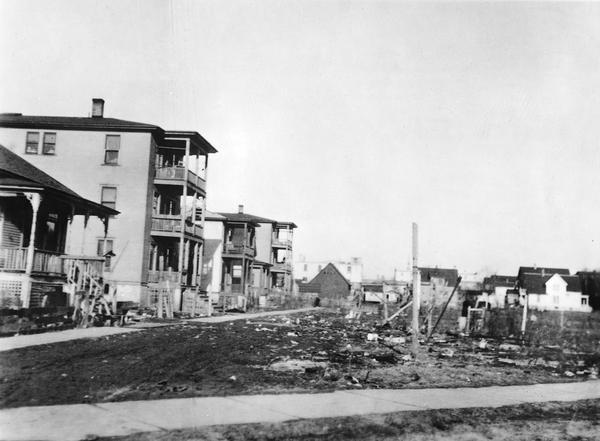 Gwinnette Court two-room tenement houses, which were inhabited by twelve families. "Note the filthy condition of the front yard." These were eliminated by an urban renewal project in about 1955. This was considered to be part of the Greenbush area.