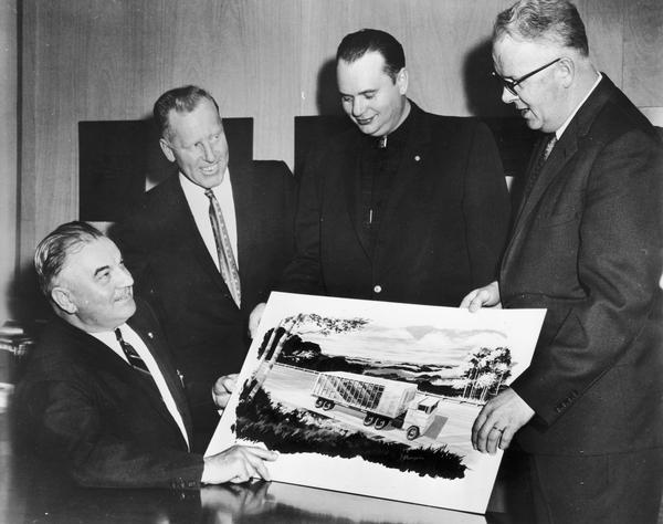 Principals in the "world's largest cheese" promotion, study the artist's sketch of the "Cheese-Mobile" that will send the cheese to the New York World's Fair in early April. They are, from left: Steve Siudzinski, Denmark, Wisconsin, maker of the 34,591 pound cheese, Amos Ossman, Denmark, and Bernie Kruse, Oshkosh, who has been selected to drive the "Cheese-Mobile" to New York, and Roland C. Behle, Rolling Prairie, managing director of the Wisconsin Cheese Foundation, primary sponsor of the huge cheese.