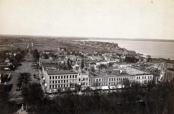 South Pinckney Street between East Washington Avenue (left) and King Street (right). On the right is the Marquette neighborhood. The large structure at the lake's edge whose cupola rises above all other buildings is the Farwell mansion.