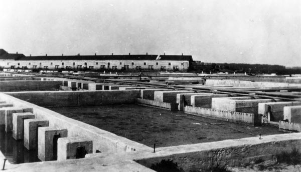 The sewage disposal plant showing the settling basins and colloidal. The main pumping station for the sewage was situated near the Chicago, Milwaukee and St. Paul tracks, just below the Yahara River. The city garbage was disposed of at Dr. West's piggery, which is in the background.