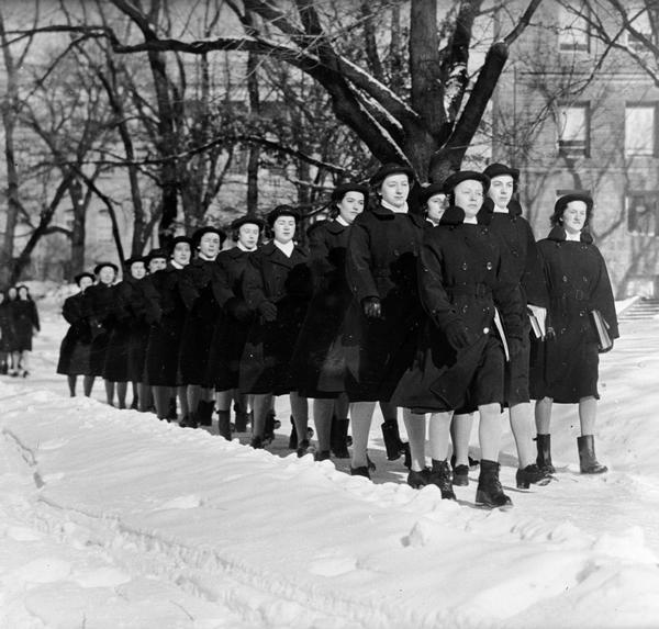 WAVES (Women Accepted for Volunteer Emergency Service) in uniform marching in snow.