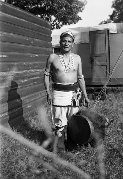 Unidentifed man with drum who was probably recorded for song collector Helene Stratman-Thomas, probably at Winnebago (HoChunk) Indian Village.