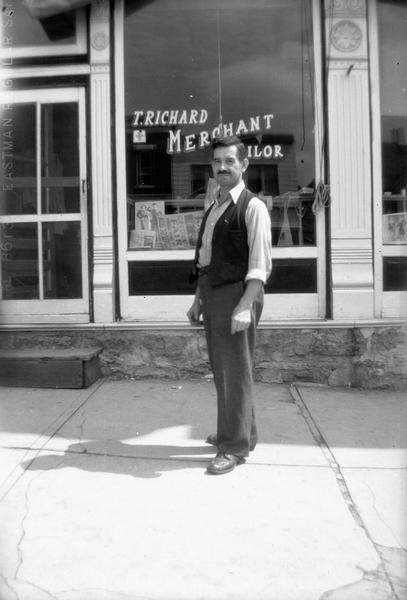 Richard Taschek, an Austrian immigrant, poses in front of his business, the T. Richard Merchant Tailor shop.