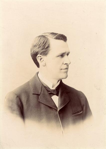 Vignetted quarter-length studio portrait of John Myers Olin.  lin was a professor of the University of Wisconsin Law School and the president of the Madison Park and Pleasure Drive Association. Olin was also known as "Father of Madison's park system and a man without peers."