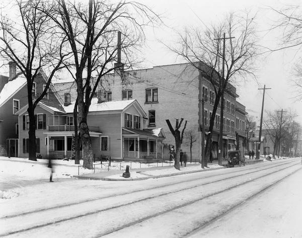 Winter scene of the 500 block of State Street, north side, Madison, Wisconsin, with corner residence.