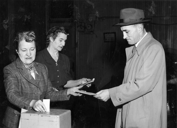 Mr. Yuenger casts the first ballot in his ward. De Pere, Wisconsin in 1952 received 100 percent voter turnout.