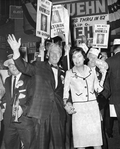 Warren P. Knowles, with Mrs. Knowles at his side, waves to his supporters during his campaign for governor.