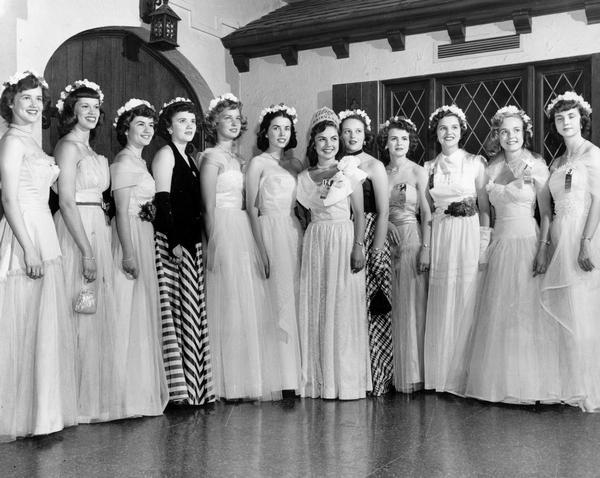 Marjean Czerwinski of Milwaukee, the 1951 Alice in Dairyland, posing with the other Alice contestants from that year wearing formal dresses. Marjean is 7th from the left.