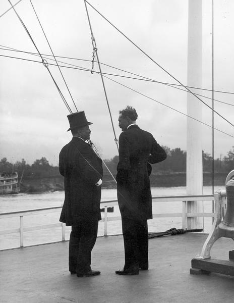 Theodore Roosevelt in top hat and Gifford Pinchot aboard the Mississippi.