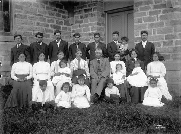 A Native American family posing outside of the Hobart Church.