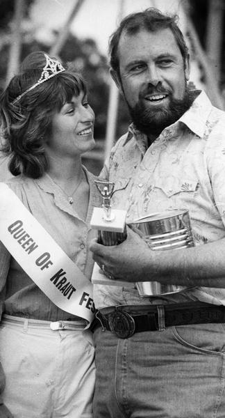 Maynard Entringer of South Milwaukee is awarded the World Championship of the Kraut Eating Contest by the Queen of the Kraut Festival, Sharon Kerkman of Burlington.