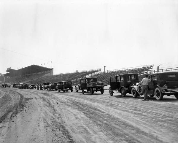 Old cars line up to race at the Wisconsin State Fairgrounds.