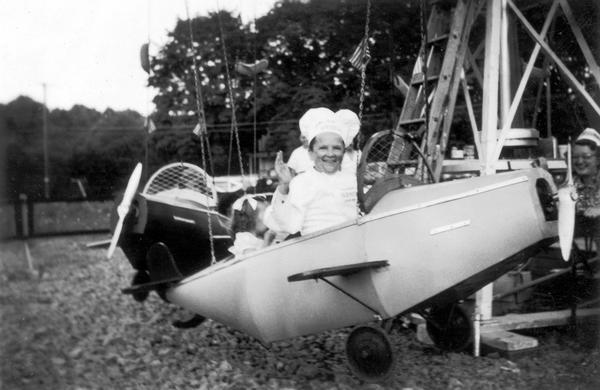 Meinhardt Raabe, dressed as Little Oscar, on an amusement park airplane ride.