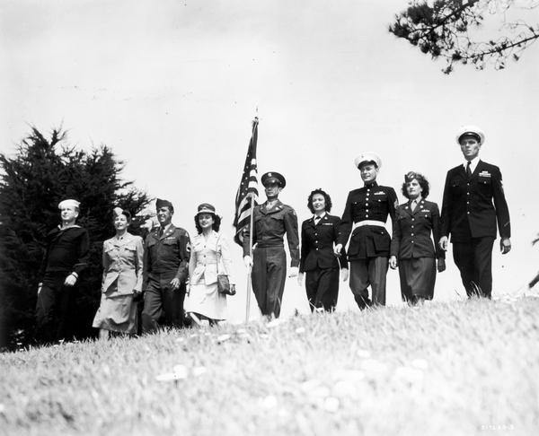 Men and women representing the various branches of the Armed Forces in a group.