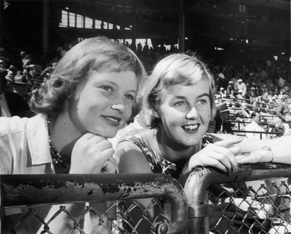 Two young British women, Hilary Birley and Cecily Thompson, watching their first baseball game at a Cubs-Braves double header.