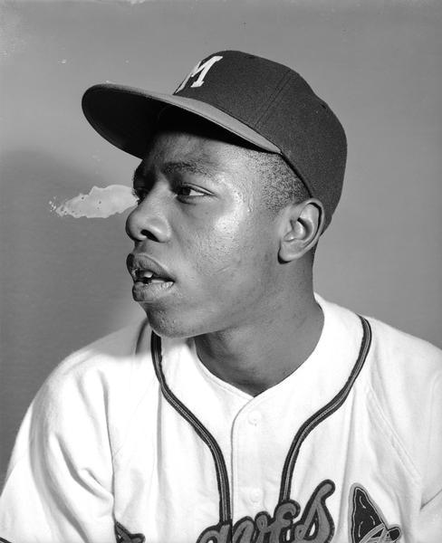 Head and shoulders portrait of Henry Aaron in baseball uniform.