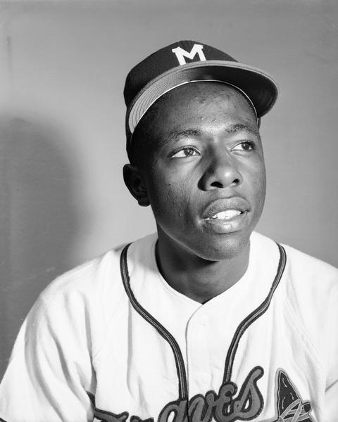 Head and shoulders portrait of Milwaukee Braves outfielder Henry "Hank" Aaron in his baseball uniform. 1954 was Aaron's rookie season.