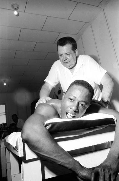 Henry Aaron on a table getting a massage.
