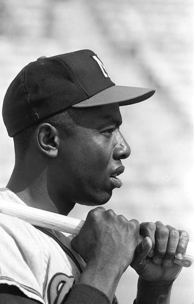 Head and shoulders profile view of Henry Aaron holding a baseball bat.