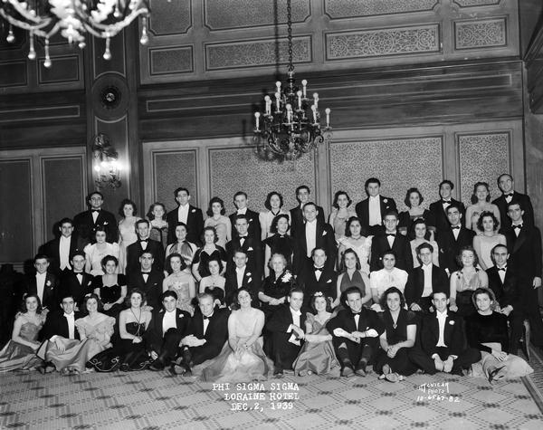Group portrait of Phi Sigma Sigma fraternity formal party in the Loraine Hotel dining room.