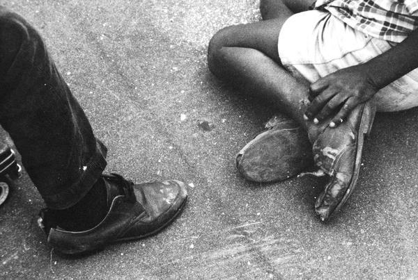 Candid shot of two people's feet taken at the Meinecke Avenue School.