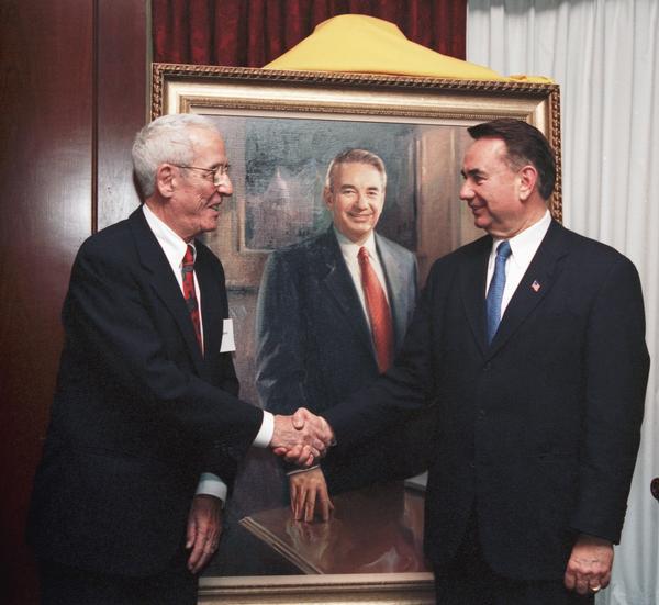 Portrait artist George Pollard (left) and former Governor Tommy G. Thompson at the unveiling of Pollard's portrait of Thompson at the Madison Club.