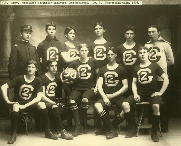 Eleven members of the 1898 basketball team representing Company G of the Wisconsin Volunteer Infantry's 2nd Regiment. Ten are in basketball uniforms, one is in military uniform.