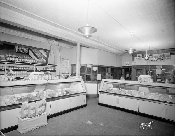Interior view of Goeden's meat counter, 635-637 University Avenue.  Cheeses and meats are arrayed in the display cases.