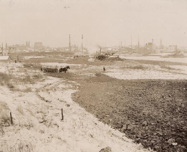 View of the construction area of the Wisconsin Central Railway, looking southeast at Shipyard Point with workers and a team of horses.