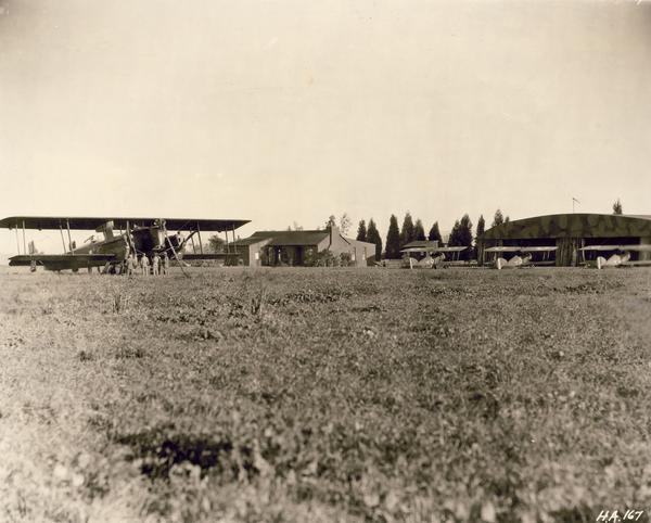 Scene at Caddo Field during the filming of "Hell's Angels," Howard Hughes' extravagant World War I aviation film.  In this scene, the large vintage Gotha brought to Hollywood from Germany by Hughes dwarfs the vintage British planes used in the production.