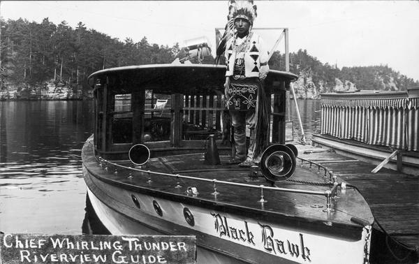 Chief Whirling Thunder, standing at the front of an excursion boat named "Black Hawk," which appears to be near the Wisconsin Dells. Caption reads: "Chief Whirling Thunder, Riverview Guide."