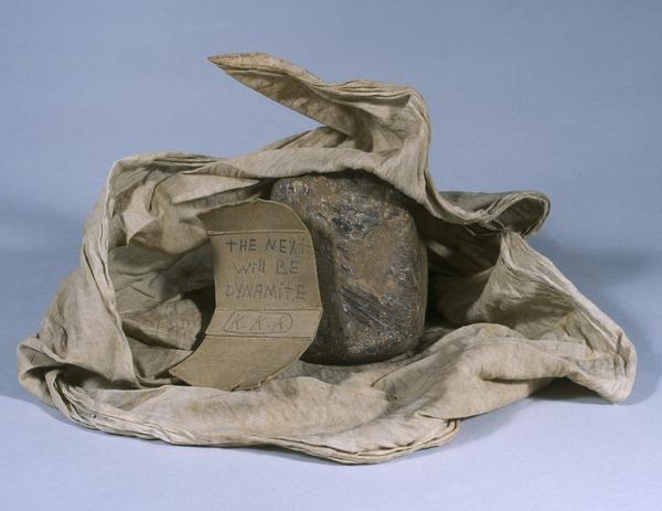 Threatening note signed "K.K.K." (Ku Klux Klan) with rock and rag that was thrown through Daisy Bates' window in August 1957. The note reads: "The next will be dynamite."