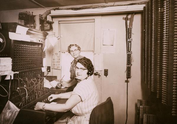 Mrs. Thompto and employee Ethel Clemens working at the telephone switchboard.