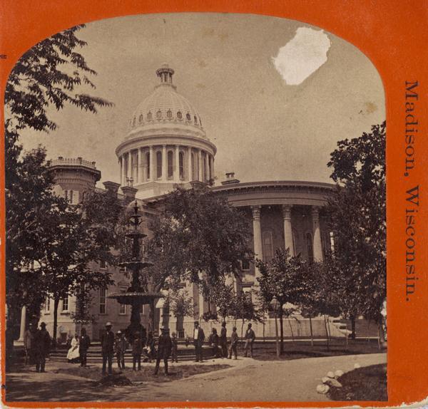 People view the third capitol building with a large fountain in front. The third Capitol was built between 1857 and 1869 and destroyed by fire on February 26, 1904.