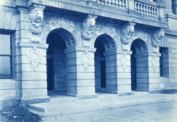 East entrance of State Historical Society of Wisconsin showing the decorative details of the building. This detail shows the four lion's heads and columns.