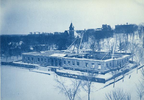 Elevated view of State Historical Society of Wisconsin, under construction, showing the first floor of building, with Music Hall in the background.