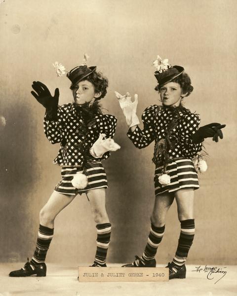 Twin sisters Julie & Juliet Gerke, students at the Kehl School of Dance, posed in matching, Kehl-designed clothing--including hats, jackets, short skirts, and oversized gloves. These were costumes for a comedy dance number. These twins were expert pianists as well and on occasion played while the Kehl twins danced.