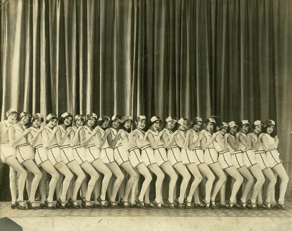 Twenty-one tap dancers from the Kehl School of Dance, posed in line formation on stage.