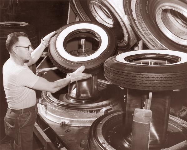A tire factory worker operating the Bag-o-matic.