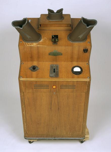 The shoe fitting fluoroscope was a common fixture in shoe stores during the 1930s, 1940s and 1950s. A typical unit, like the machine shown here, consisted of a vertical wooden cabinet with an opening near the bottom into which the feet were placed. When you looked through one of the three viewing ports on the top of the cabinet (e.g., one for the child being fitted, one for the child's parent, and the third for the shoe salesman or saleswoman), you would see a fluorescent image of the bones of the feet and the outline of the shoes.