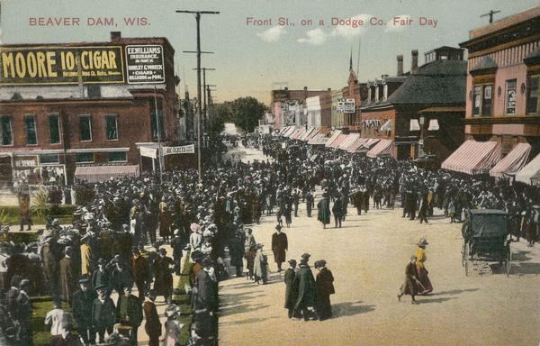 Crowds on Front Street during Dodge County Fair day, circa 1910-1915. Caption reads: "Front St., on a Dodge Co. Fair Day."