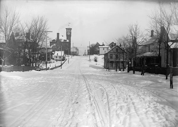 Main Street in winter, including a clock tower.