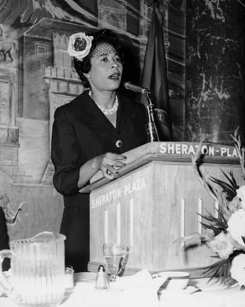 Daisy Bates speaking at the podium at a breakfast given in her honor at the Sheraton Plaza.