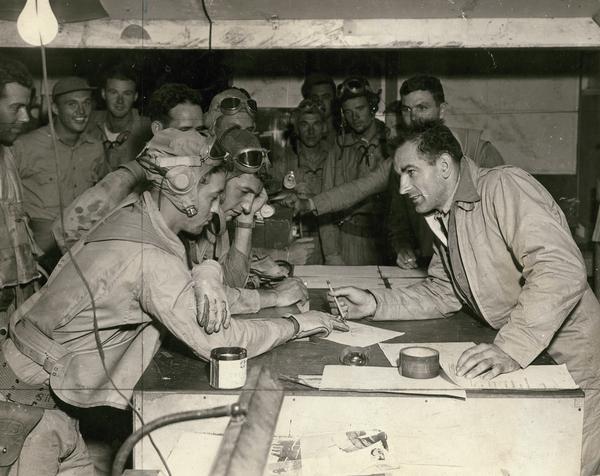Captain Joseph R. McCarthy, a Marine intelligence officer, interviewing pilots who have just returned from raids on Japanese installations in the Solomon Islands.