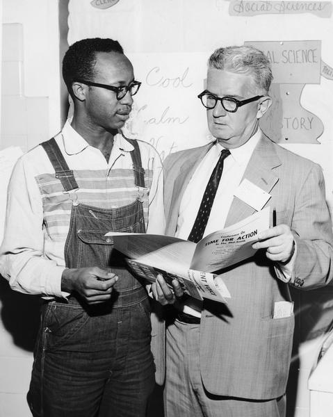 Charles Sherrod and Carl Braden looking over a "Time for Action" paper.