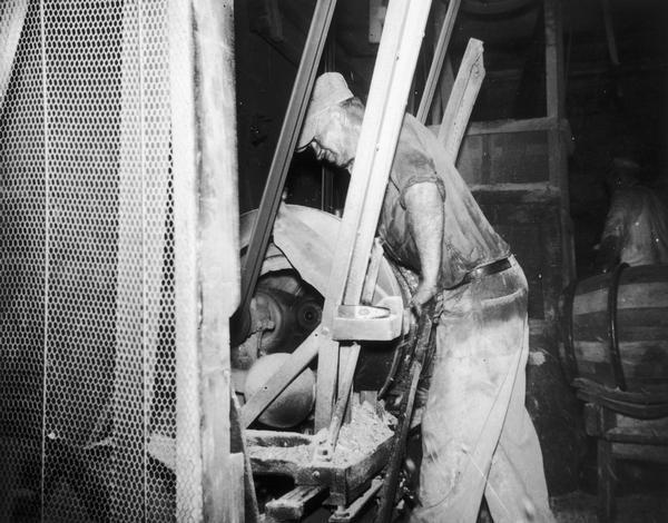 Joe Hess using a crozing machine to shape an oak barrel at the Hess Cooperage.